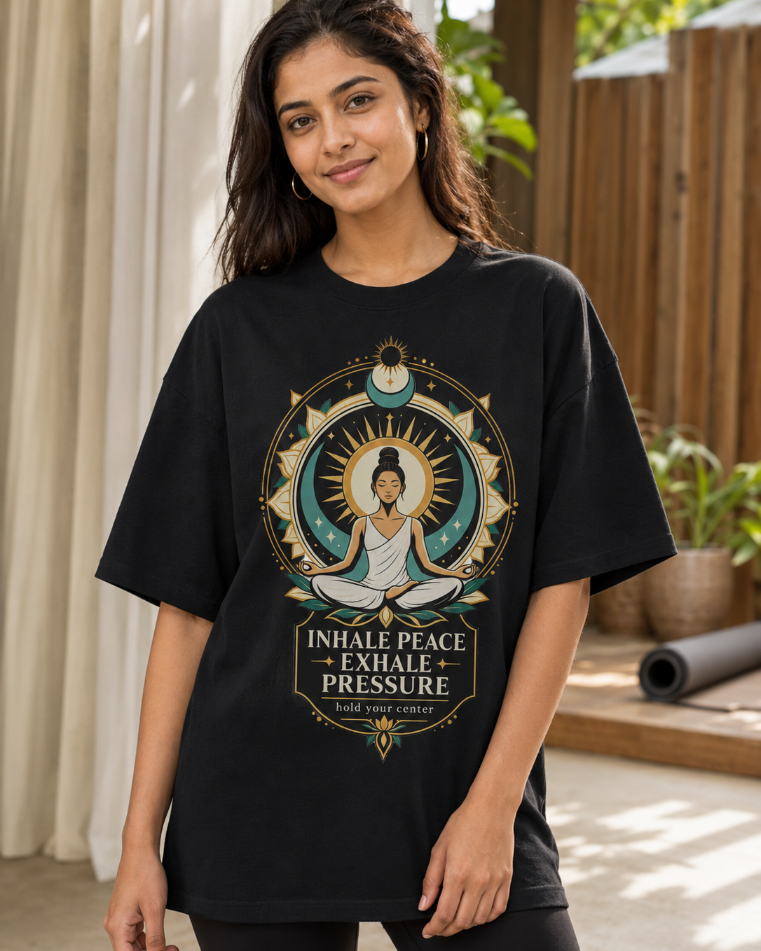 Woman wearing black Inhale Peace yoga meditation oversized T-shirt