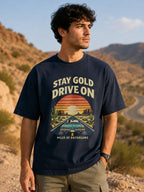 Model wearing Stay Gold Drive On oversized T-shirt in navy blue