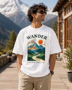 Man wearing REBELO Wander white oversized graphic T-shirt outdoors